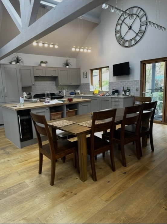 Barn conversion kitchen with vaulted ceiling and track lighting
