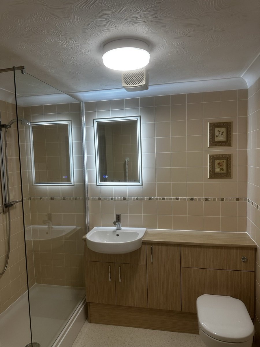 Modern bathroom with LED backlit mirror