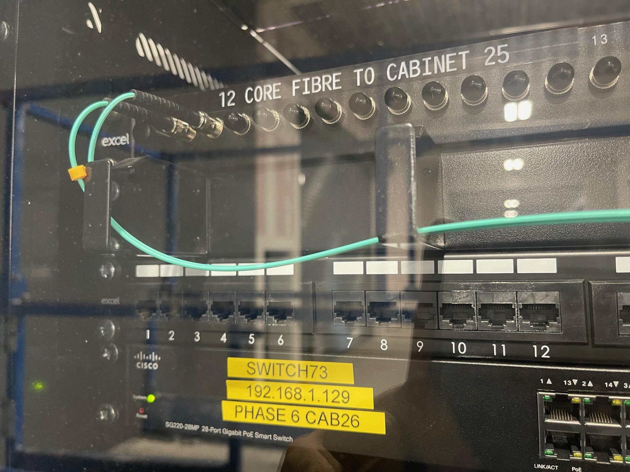 Managed PoE switch, patch panel and fibre tray inside a 27U comms cabinet