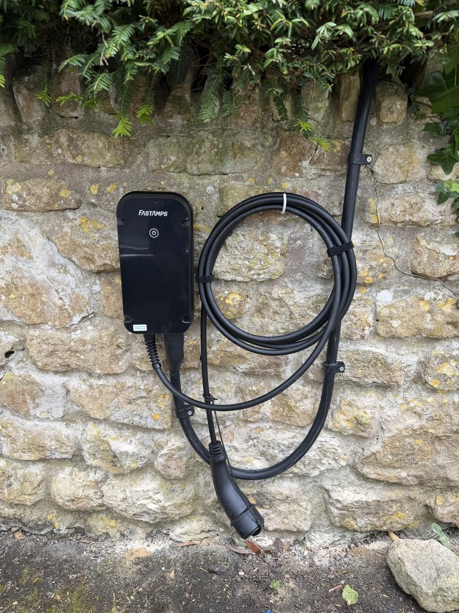 Home EV charger mounted on a stone wall