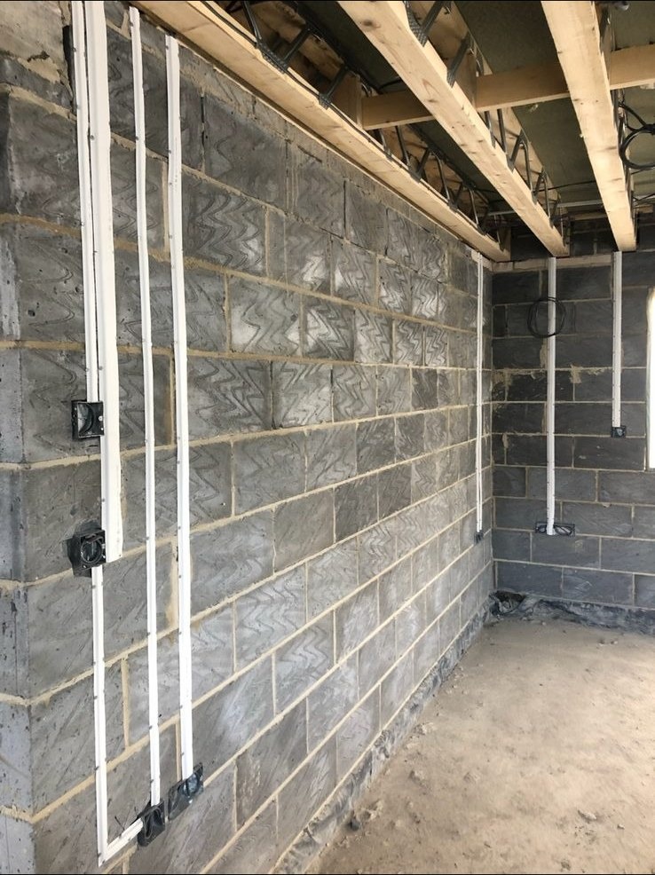 Commercial first-fix conduit and cable routing on blockwork by DS Electrical