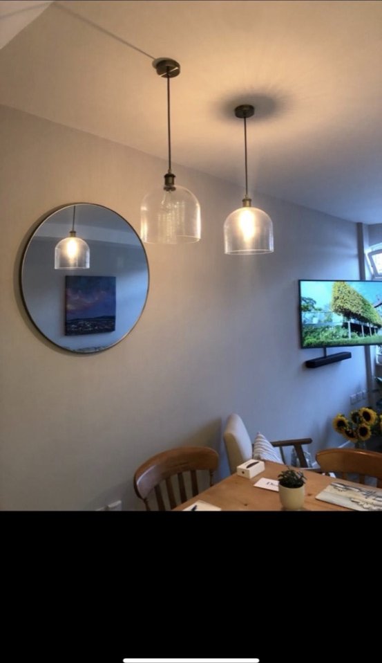 Glass pendant lights over dining table