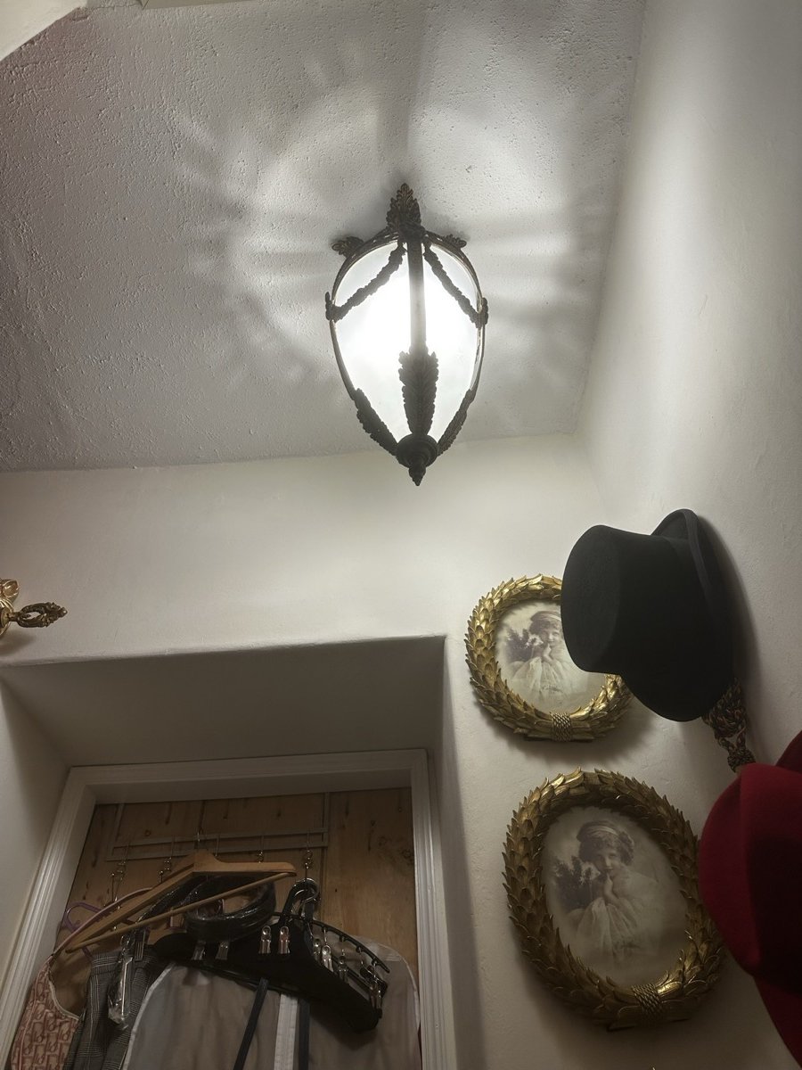 Ornate period wall sconce with cast shadow
